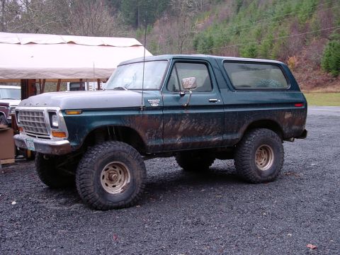 1979 Ford Bronco - This lifted Ford Bronco has a two-tone paint job and appears to be covered in mud.