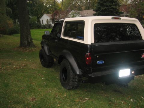 1995 Ford Bronco - This lifted Ford Bronco features a two-tone black and tan paint scheme and aggressive off-road tires.