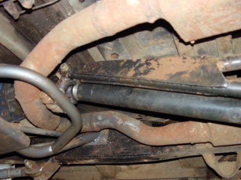 1979 Ford Bronco - The underside of a vehicle is visible, with various mechanical components and signs of rust.