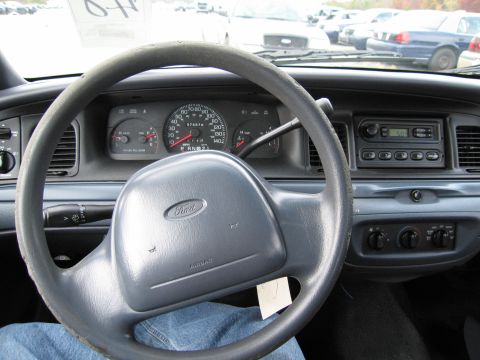 1991 Ford LTD Crown Victoria - The interior of a 1991 Ford Crown Victoria LTD is visible, including the steering wheel, dashboard, and instrument cluster.