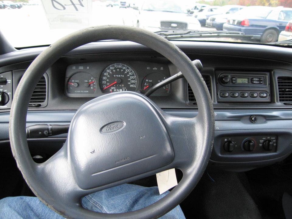 1991 Ford Crown Victoria LTD interior with a gray steering wheel and dashboard, showing the instrument cluster and radio