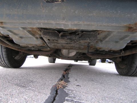 1991 Ford LTD Crown Victoria - The underside of a 1991 Ford Crown Victoria LTD reveals its rear differential and exhaust system.