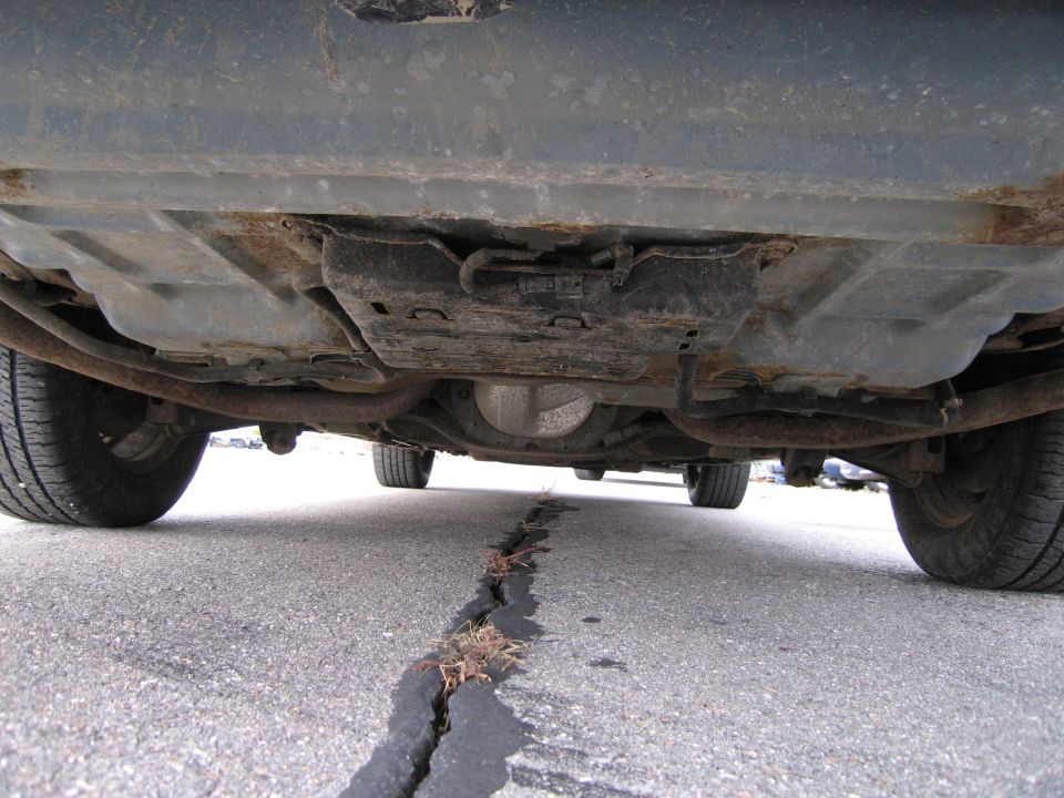 1991 Ford Crown Victoria LTD underside, showing rusted exhaust and differential