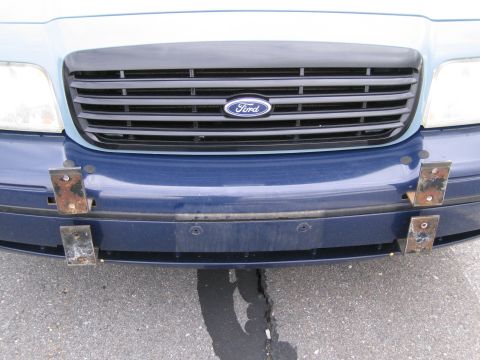 1991 Ford LTD Crown Victoria - Front view of a blue Ford Crown Victoria showing its grille and bumper with added mounting hardware.