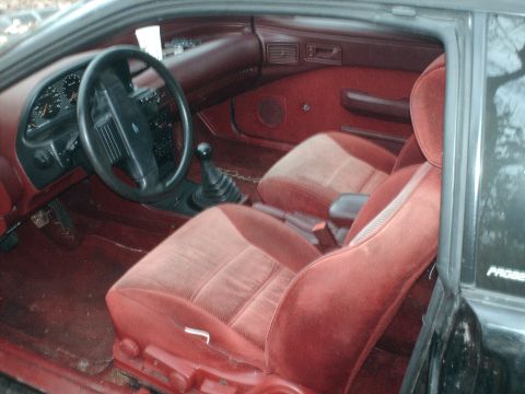 1996 Ford Probe - The interior of a 1993 Ford Probe features red velour seats and a manual transmission.