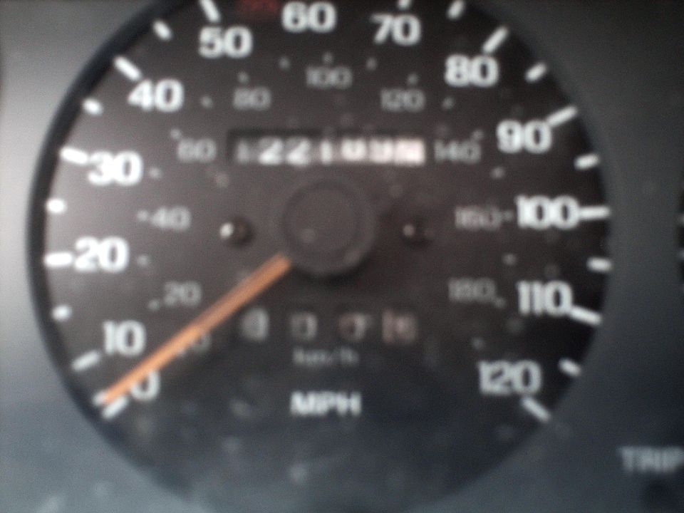 Car speedometer showing 0 MPH, odometer reads 122109.6