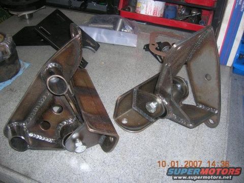 1984 Ford Bronco - Two custom-fabricated metal brackets are displayed on a workbench, with a date stamp indicating they were photographed on October 1, 2007.