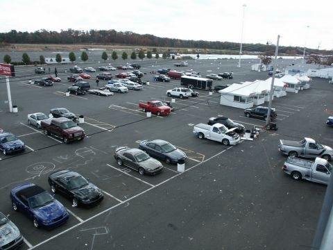 2001 Mercury Grand Marquis - A large parking lot scene with many vehicles present under an overcast sky.