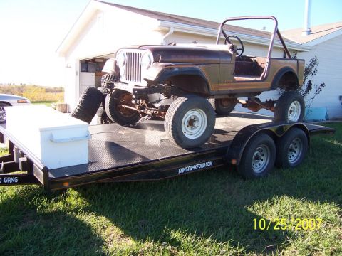 1995 Ford Bronco - A brown Jeep CJ-5 is loaded onto a trailer, accompanied by spare tires and a white toolbox. The date 10/25/2007 is visible.