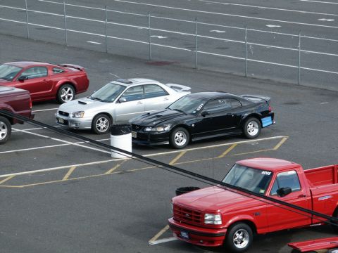 2001 Mercury Grand Marquis - Several cars are parked on a track, including a black Ford Mustang and a red pickup truck.