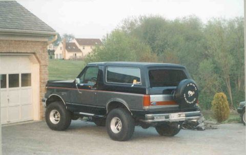 1990 Ford Bronco - This 1990 Ford Bronco is shown from the rear, parked in front of a garage.