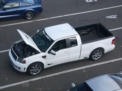 2001 Mercury Grand Marquis - White Saleen pickup truck and a blue Ford Mustang parked on asphalt.