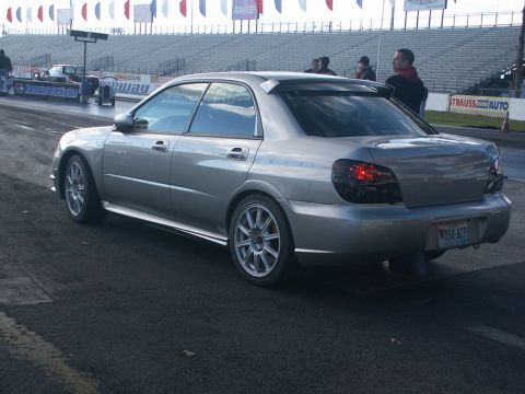 2001 Mercury Grand Marquis - Silver Subaru Impreza WRX sedan at a drag strip event.