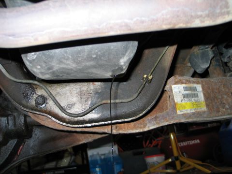 1994 Ford Bronco - Undercarriage view shows oil leaking from a component.