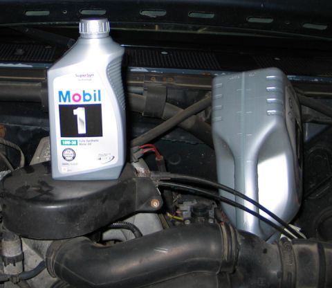 1994 Ford Bronco - Mobil 1 oil bottles placed in an engine bay.