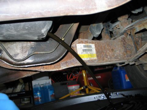 1994 Ford Bronco - Changing the oil on a vehicle, showing the old oil draining out.