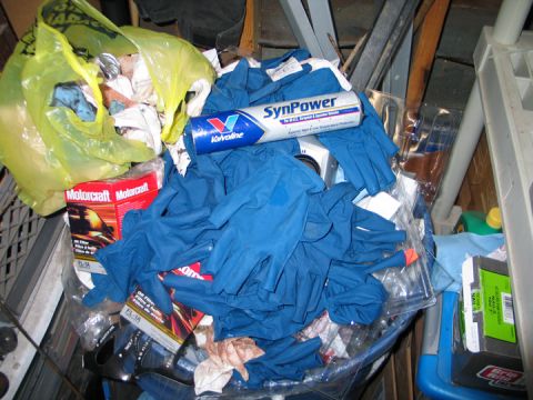 1994 Ford Bronco - A collection of automotive maintenance supplies including gloves, oil filters, and a bottle of synthetic oil.