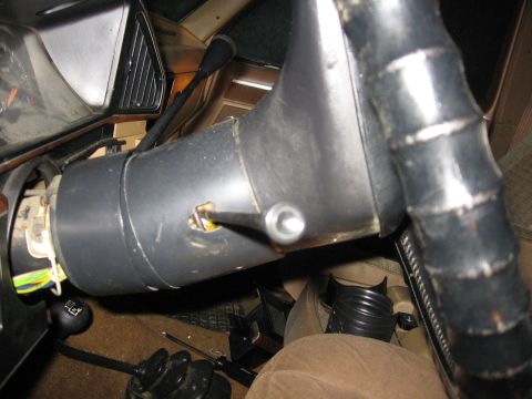 1987 Ford Bronco - Interior view of a vehicle's steering column assembly, showing the ignition and shift lever.