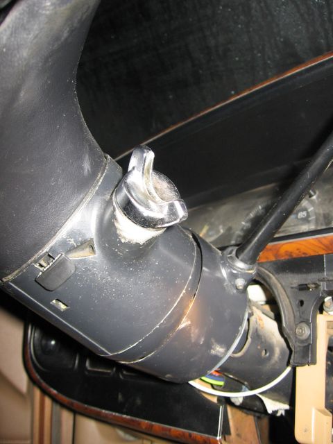1987 Ford Bronco - Close-up of a vehicle's steering column ignition switch assembly.