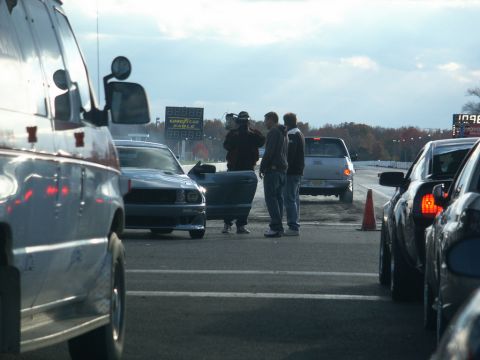 2001 Mercury Grand Marquis - Cars and people at a drag strip with a scoreboard in the background.