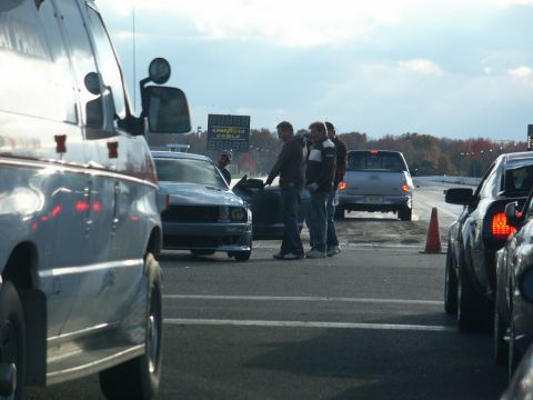 2001 Mercury Grand Marquis - Vehicles staged at a drag strip, with a scoreboard displaying times in the distance.