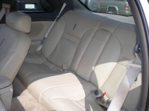 1995 Ford Thunderbird - Interior view of a Lincoln Mark VIII, showing the rear seating area and a glimpse of another vehicle outside.