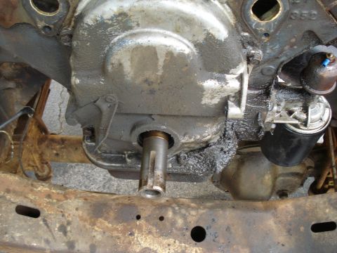 1967 Ford F-250 - Close-up view of an engine's crankshaft seal area, showing oil residue and an attached oil filter.