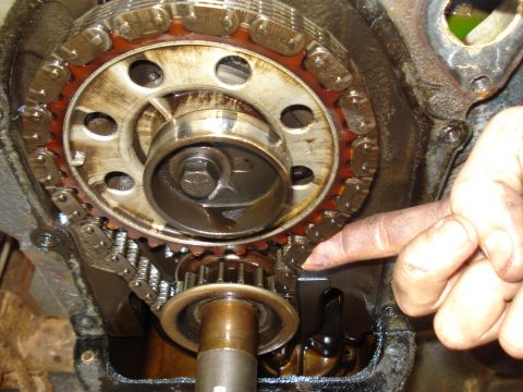 1967 Ford F-250 - A close-up view of the internal workings of an engine, focusing on the timing chain and gears.