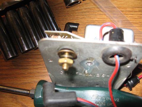 1968 Shelby GT500 - Close-up of an automotive electrical part with visible wiring and mounting hardware.
