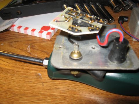 1968 Shelby GT500 - Close-up of an electronic component, a circuit board and wiring, resting on a wooden surface.