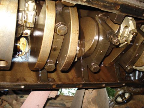 1967 Ford F-250 - Close-up view of the internal components of an engine, including the crankshaft and connecting rods.