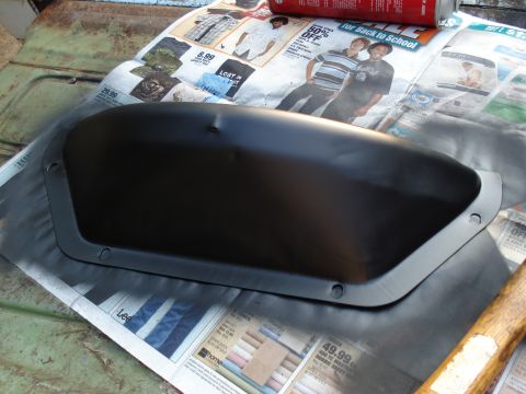 1967 Ford F-250 - A black painted automotive part is placed on newspaper, possibly for painting or drying.