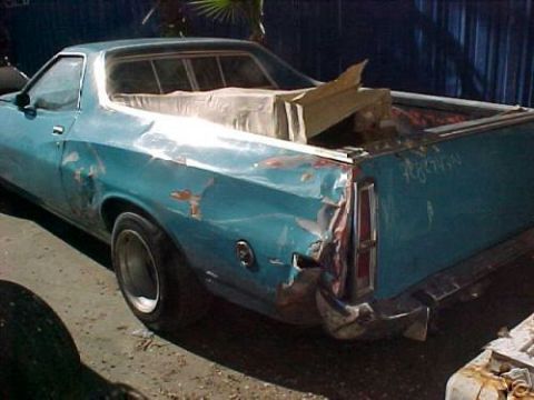 1972 Ford Ranchero - This pickup truck has significant damage to its rear passenger side.