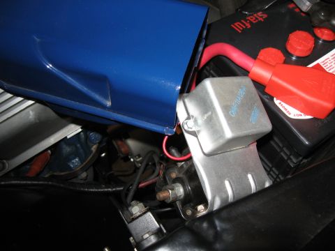 1968 Shelby GT500 - Close-up of a starter relay and battery, possibly from a classic car, with a blue shroud.