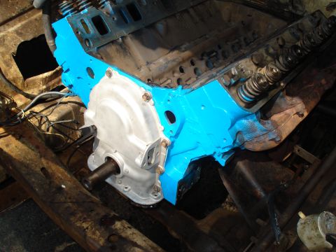 1967 Ford F-250 - Close-up view of a partially assembled engine block with blue paint and silver components.