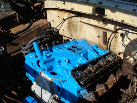 1967 Ford F-250 - Close-up view of a blue engine block, showing internal components and surrounding engine bay elements.