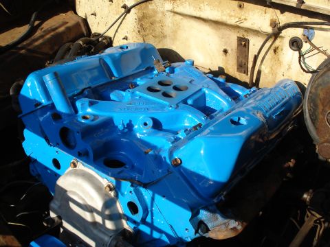 1967 Ford F-250 - Close-up of a blue painted V8 engine, likely a Ford 360, with intake manifold and valve covers.