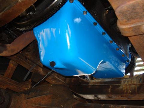 1967 Ford F-250 - Close-up view of a bright blue oil pan attached to an engine block.