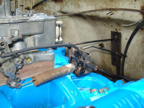 1967 Ford F-250 - The throttle linkage and a large return spring are visible on the engine's carburetor assembly.
