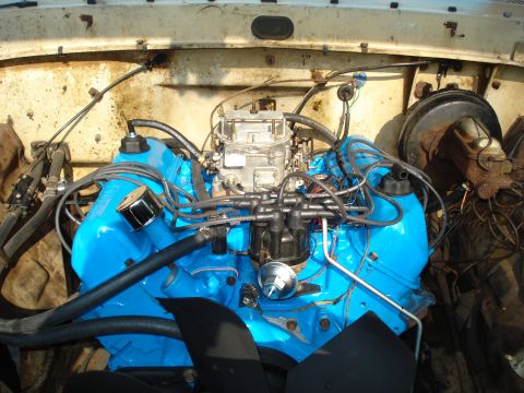 1967 Ford F-250 - Close-up view of a vehicle's engine bay, showing the engine and its components.