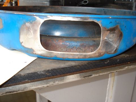 1967 Ford F-250 - Close-up of a blue engine component showing signs of rust and repair work.