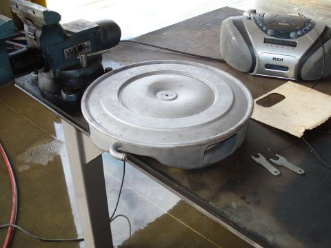 1967 Ford F-250 - An engine part sits on a workbench with tools and a radio nearby.