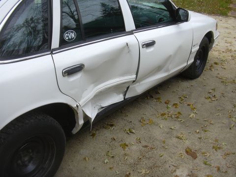 1997 Ford Crown Victoria - This 1997 Ford Crown Victoria shows significant damage to its side, impacting both rear doors.