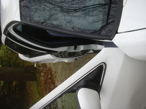 1997 Ford Crown Victoria - Close-up view of a car's side door frame and exterior mirror.