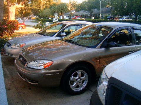 2002 Ford Taurus - Two 2002 Ford Taurus sedans are parked next to each other on a sunny day.