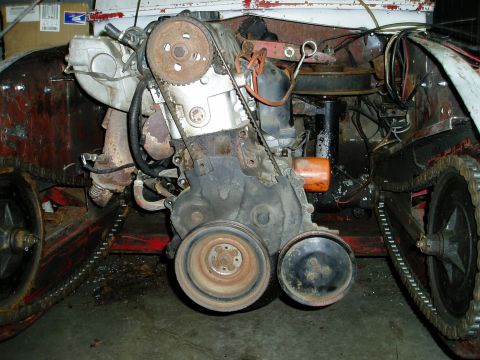 2000 Ford E350 - Close-up of an engine and track system, likely from a custom vehicle or modification.