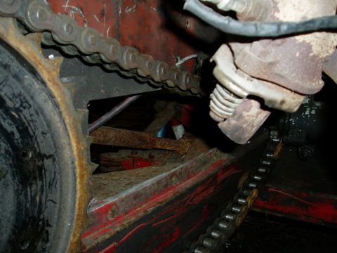 2000 Ford E350 - Close-up view of a vehicle's drive chain and exhaust system components, showing signs of rust and wear.