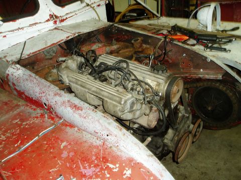 2000 Ford E350 - Vehicle engine bay showing engine components and unfinished bodywork.