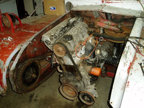 2000 Ford E350 - Close-up of a turbo engine in a vehicle's engine bay, with visible mechanical components and wiring.