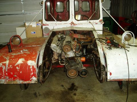 2000 Ford E350 - Custom tracked vehicle undergoing engine work in a garage.